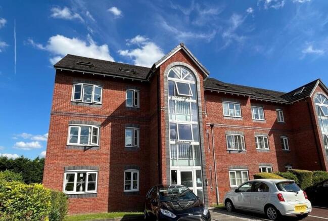 Red-brick apartment building with attractive ar...