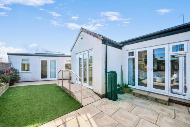 Rear view of the property and garden room