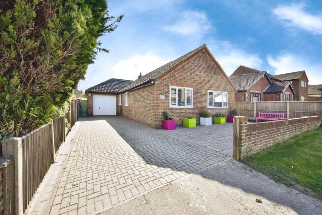 Outside View Of The Property With Driveway Parking