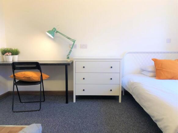 Bright and tidy bedroom featuring a clean white...