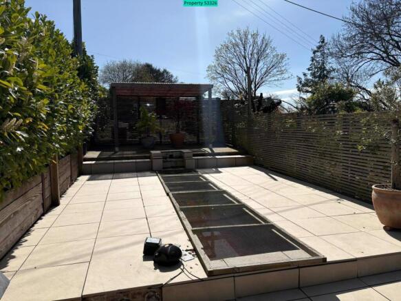 Paving and long fish pond, pergola 
