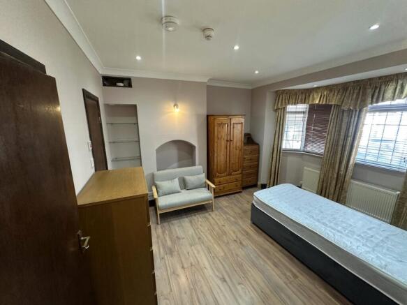 Spacious bedroom with ample storage and seating...