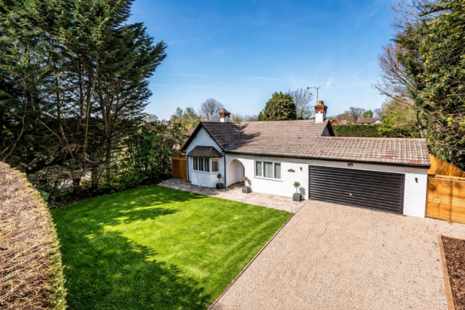 Charming bungalow with lush lawn.png