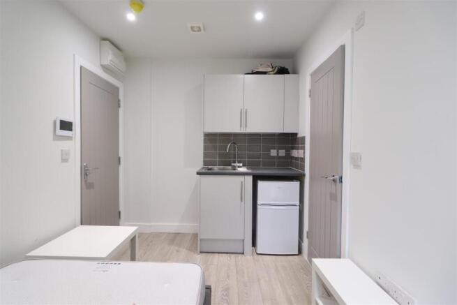 Bright, compact studio with a fitted kitchenett...