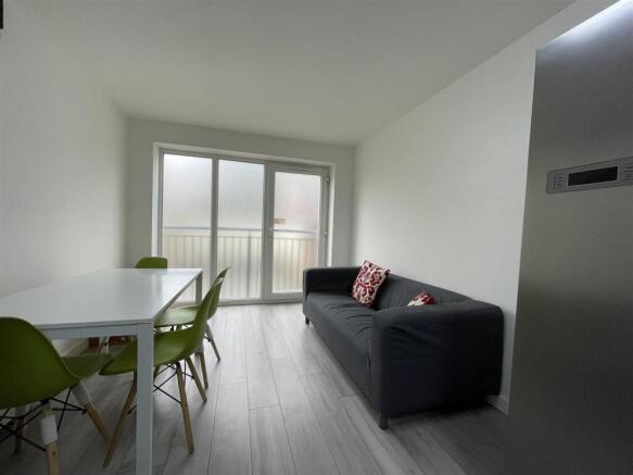 Bright modern living area with dining set...