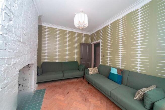 Spacious lounge with matching green sofas...