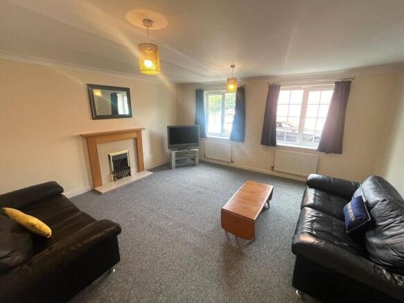 Bright, well-kept living room with two large fr...