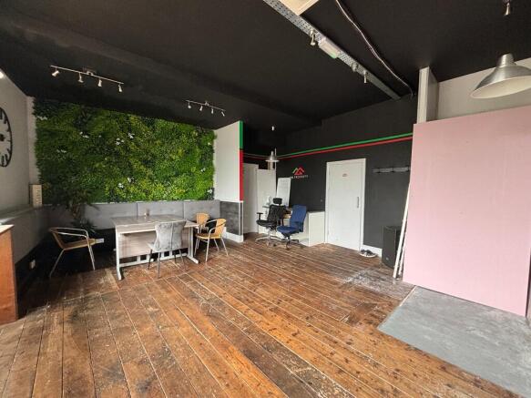 Spacious modern workspace with vibrant green wa...