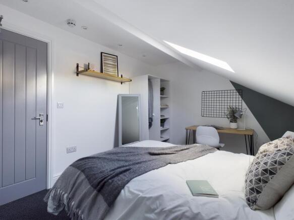 Bright, stylishly decorated double bedroom with...