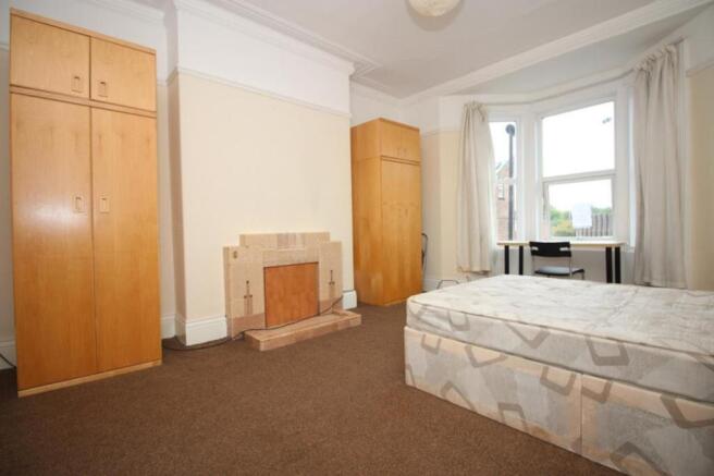 A spacious and well-lit double bedroom featurin...