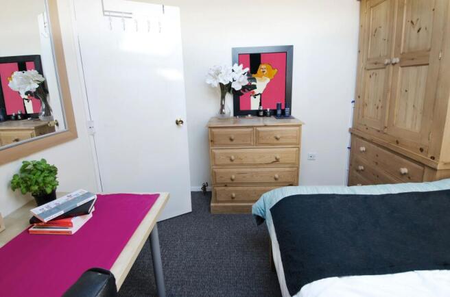 Bright, neatly presented bedroom with a comfort...