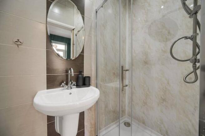 Modern shower suite with elegant marble tiling...