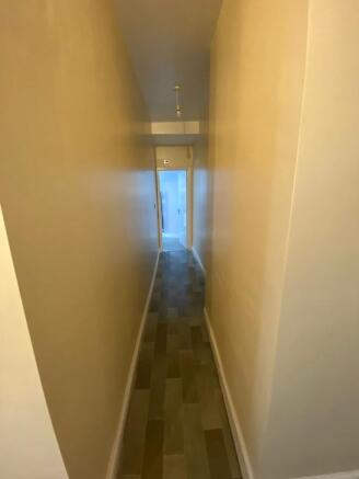 Clean hallway with modern wood-effect flooring...