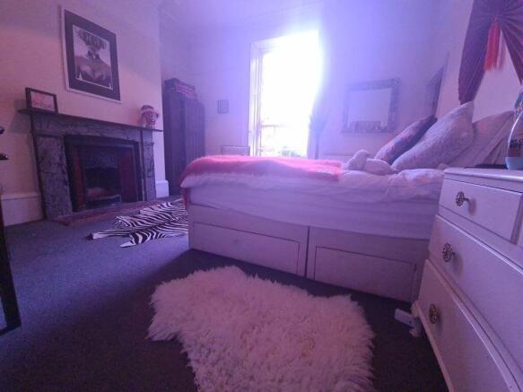 A spacious and well-maintained bedroom featurin...