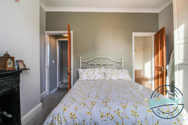 Front bedroom with stairs to loft room