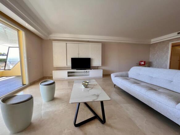 Modern living room with a large white sofa, marble