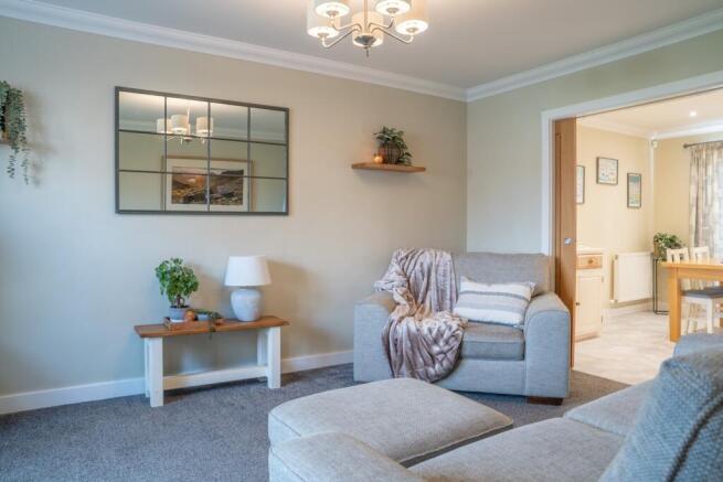 Lounge With Sliding Oak Doors To Kitchen Diner