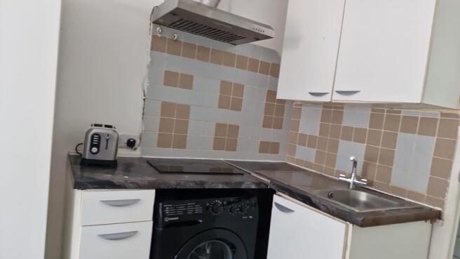 Bright kitchen with modern hob and washing mach...