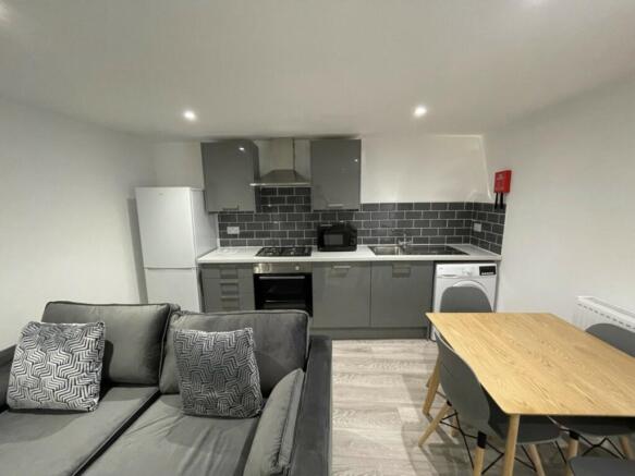 A modern and stylish kitchenette with ample spa...