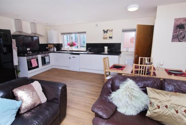 Bright, modern open-plan living area with a con...