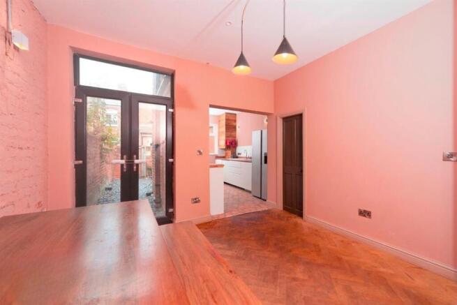 Bright lounge with wooden floors and pendant la...