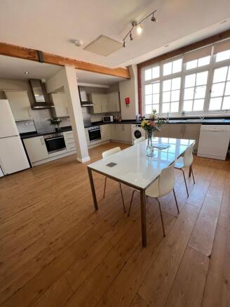 Bright, modern open-plan kitchen with large mul...