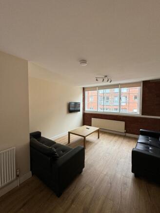 Bright, modern living room with large windows, ...