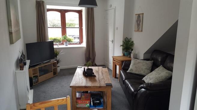 A bright and cozy living room featuring a large...