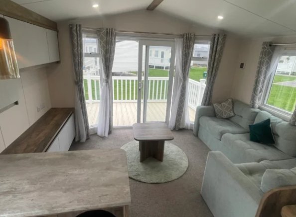 Bright open plan lounge with patio doors in Willer
