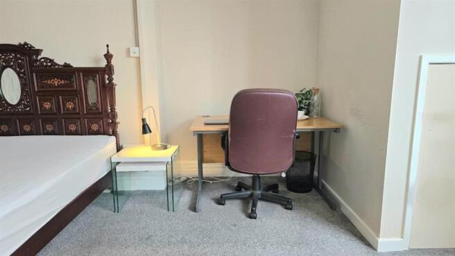 Bright bedroom with study desk and double bed...