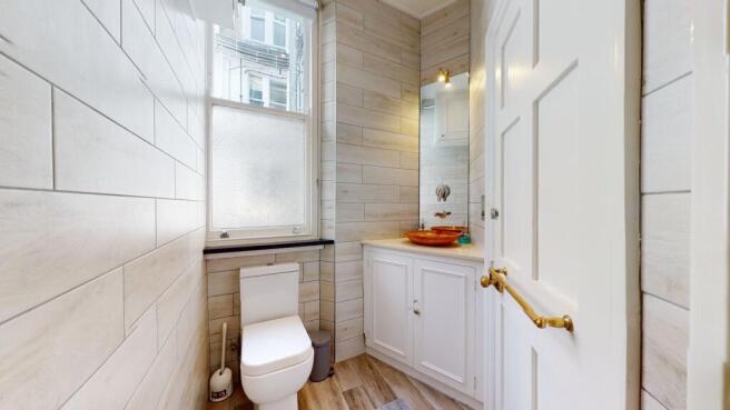 Bright and neat bathroom featuring modern fitti...