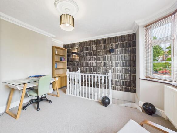 Versatile office space and stairs leading to Basement Living Space