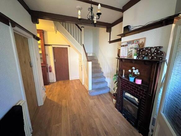 A bright and welcoming hallway featuring wooden...