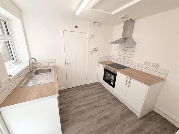 Modern bright kitchen with sleek white cabinets...