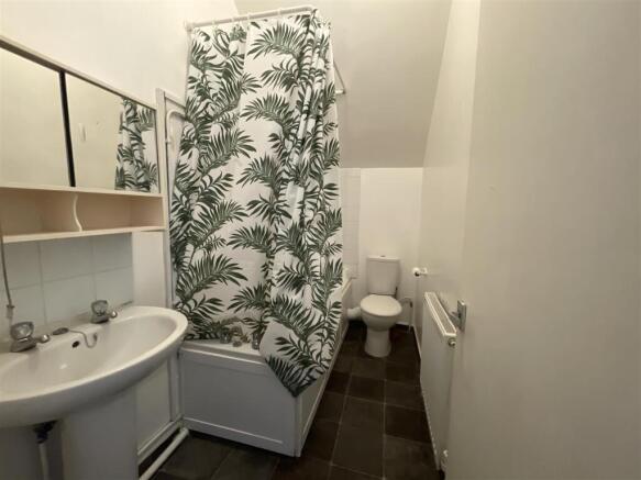 Bright bathroom with bath and stylish curtain...