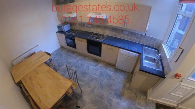Bright, modern kitchen with integrated oven and...