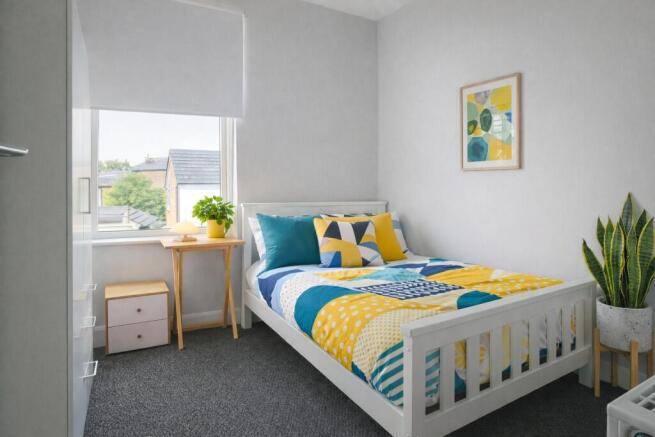 Bright, neatly presented bedroom with a white w...