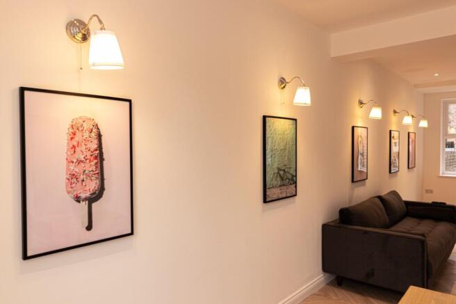 A modern, well-lit living room featuring warm l...