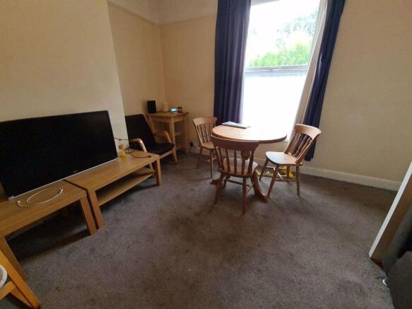 A cozy living room featuring a large window all...