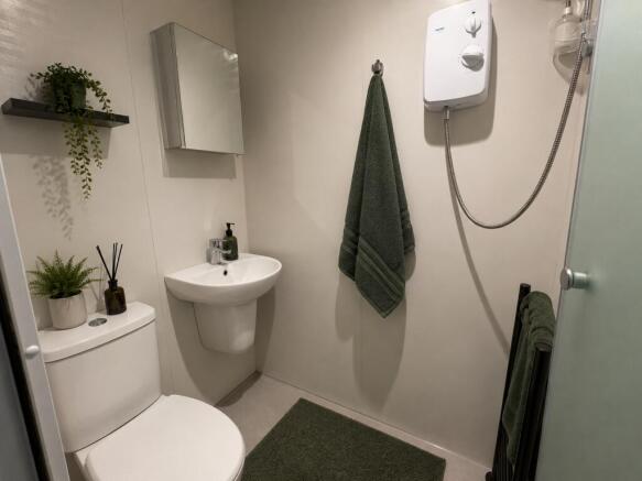 Modern shower room with fresh green accents...