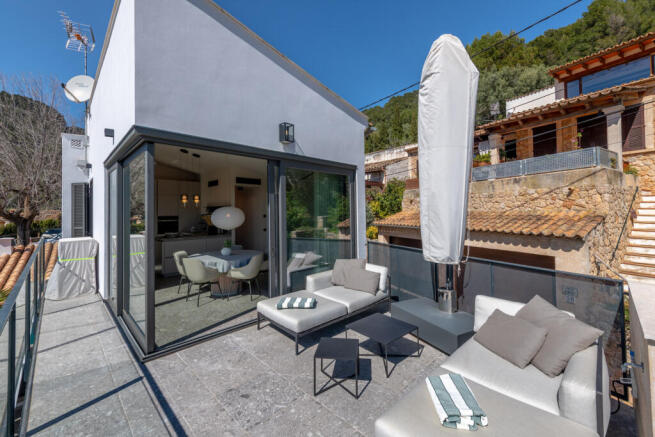 Modern rooftop terrace with seating area and access to the open-plan kitchen