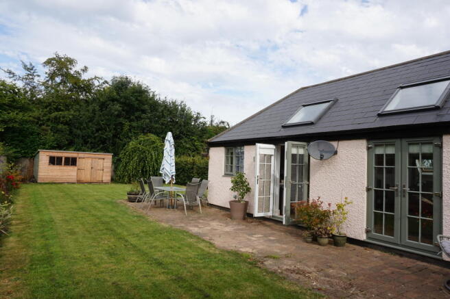 Paved patio and side garden
