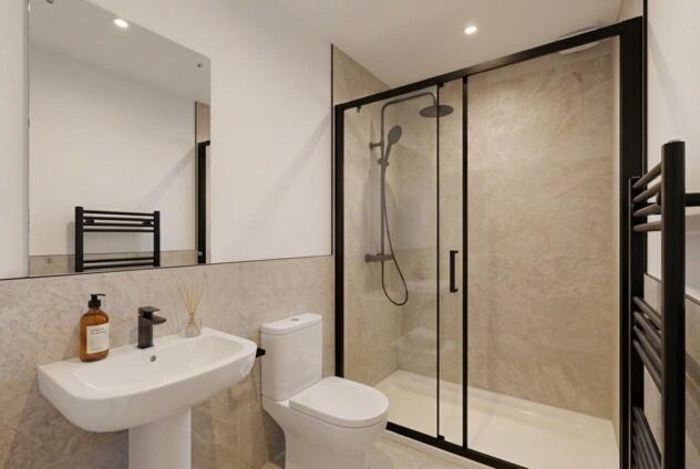 Sleek modern bathroom with rainfall shower...