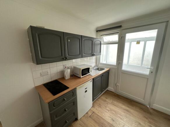 Compact fitted kitchen with modern units and li...