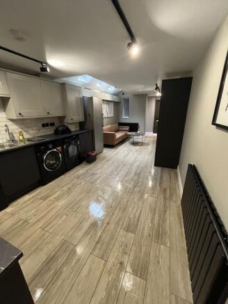 Modern open-plan living area with a fitted kitc...