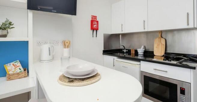 Sleek modern kitchenette with breakfast bar...
