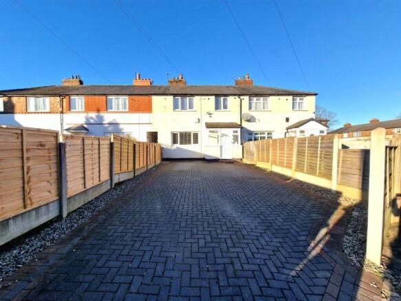 Bright and spacious driveway leading to a well-...
