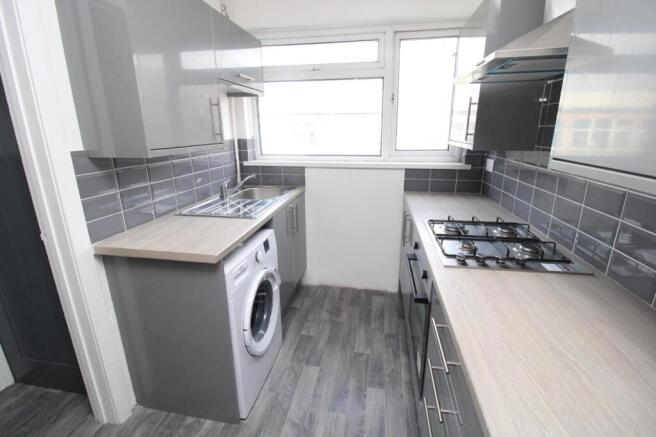 Modern galley kitchen with sleek grey cabinets...