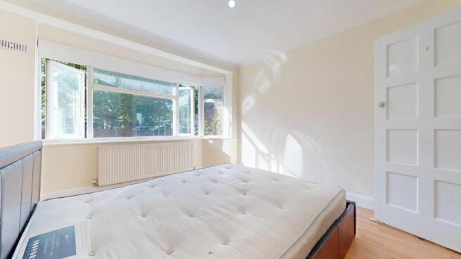Bright bedroom with large bay window...