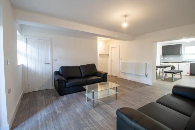 A spacious, well-maintained living room featuri...